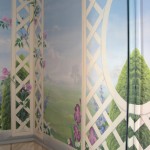 Bathroom hand painted mural with blue sky, garden and lattice fence and flowers